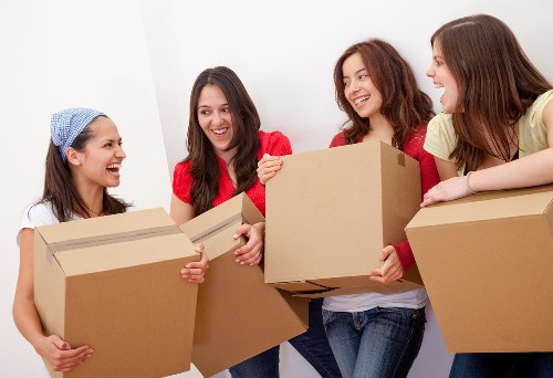 Local movers handling furniture in a St Lukes apartment access area